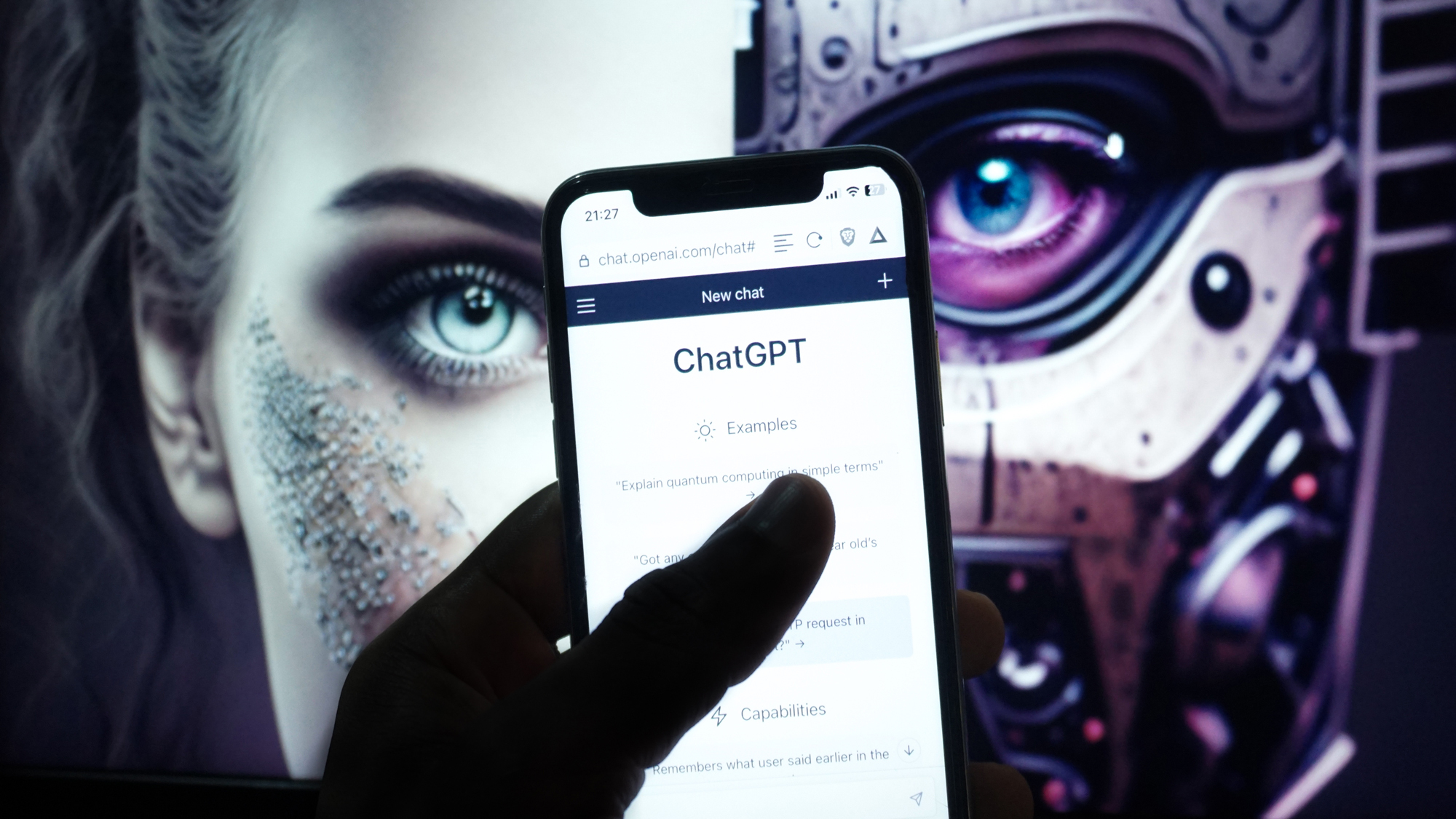 human vs. robot face with ChatGPT on phone