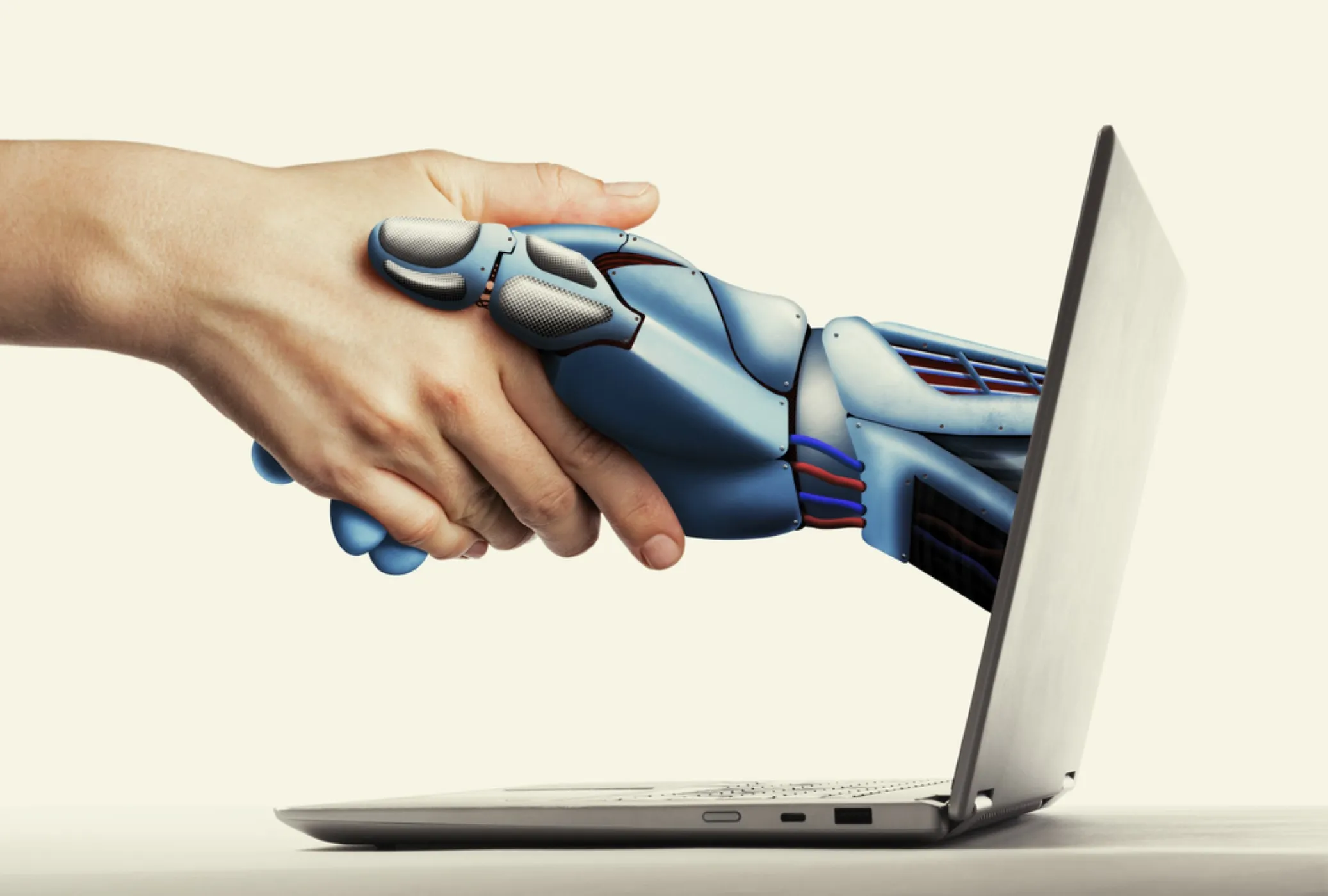Human hand shaking a robot hand implying artifical intelligence