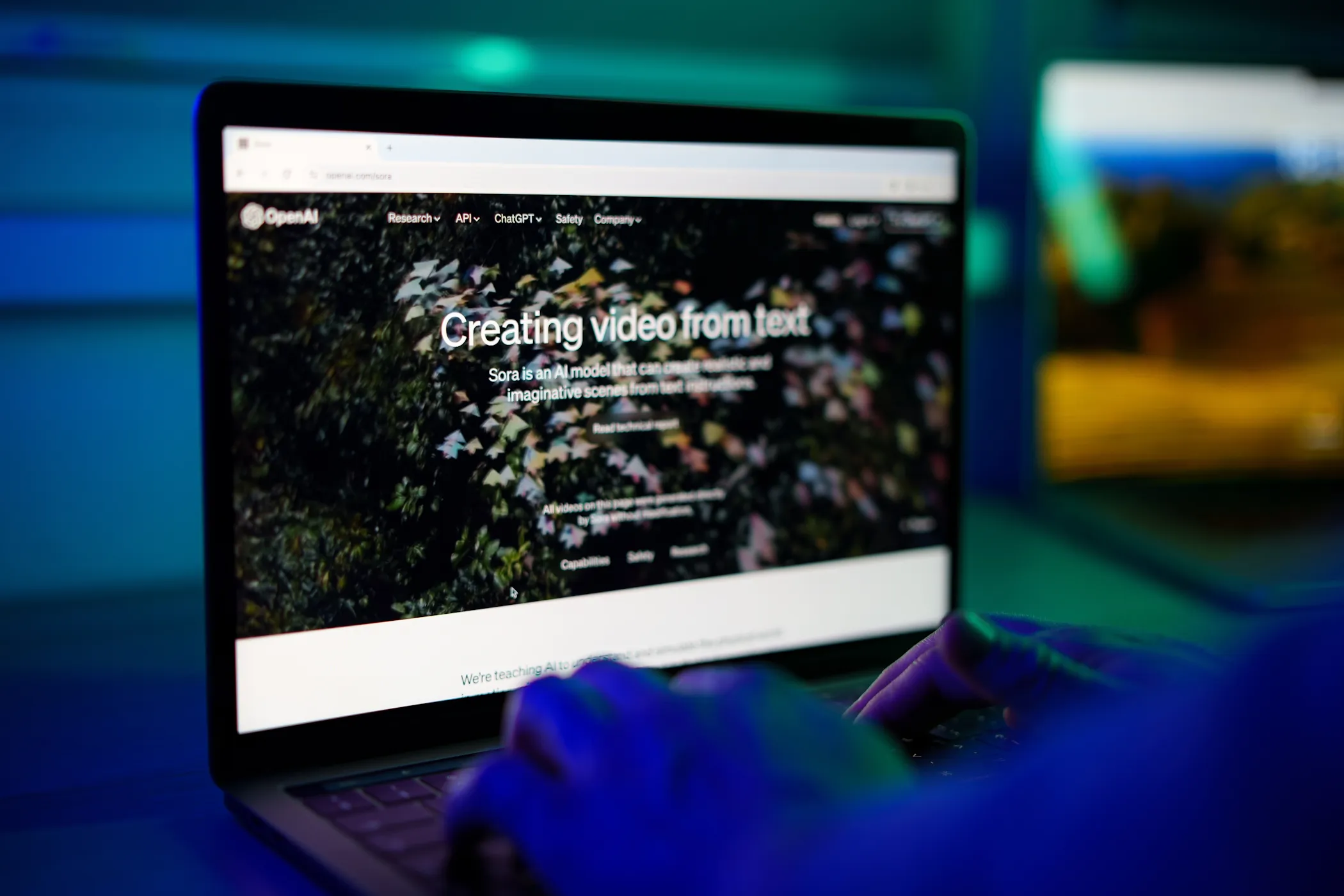 sora openai webpage home on laptop screen in rgb lighting.