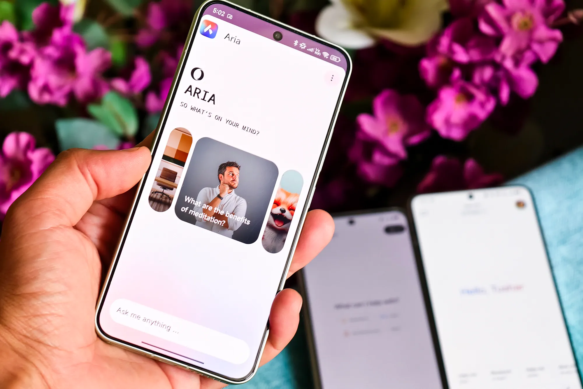 Opera Mini Aria AI chatbot on phone held in hand.