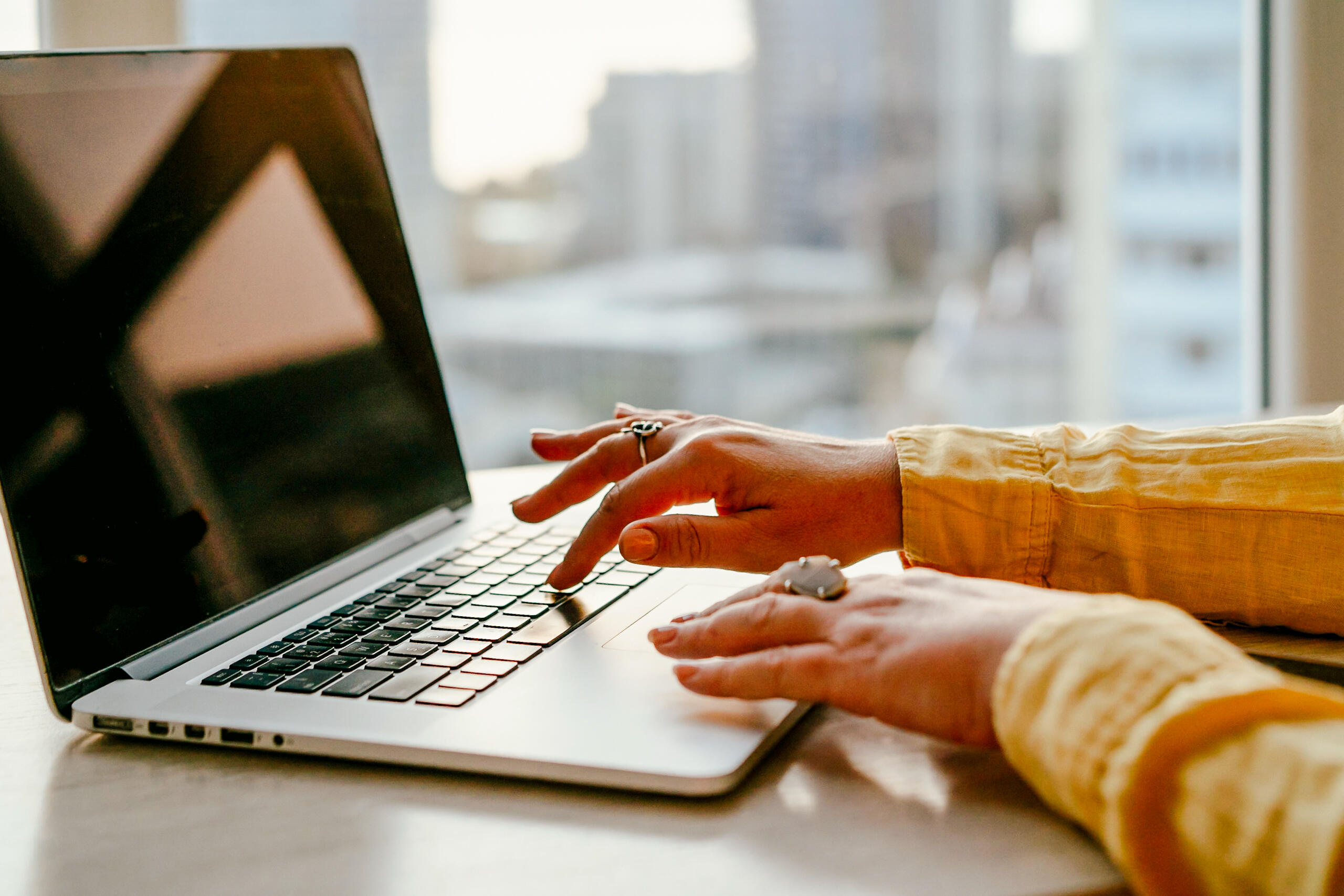 An image of hands typing on a laptop gettyimages-2157361694