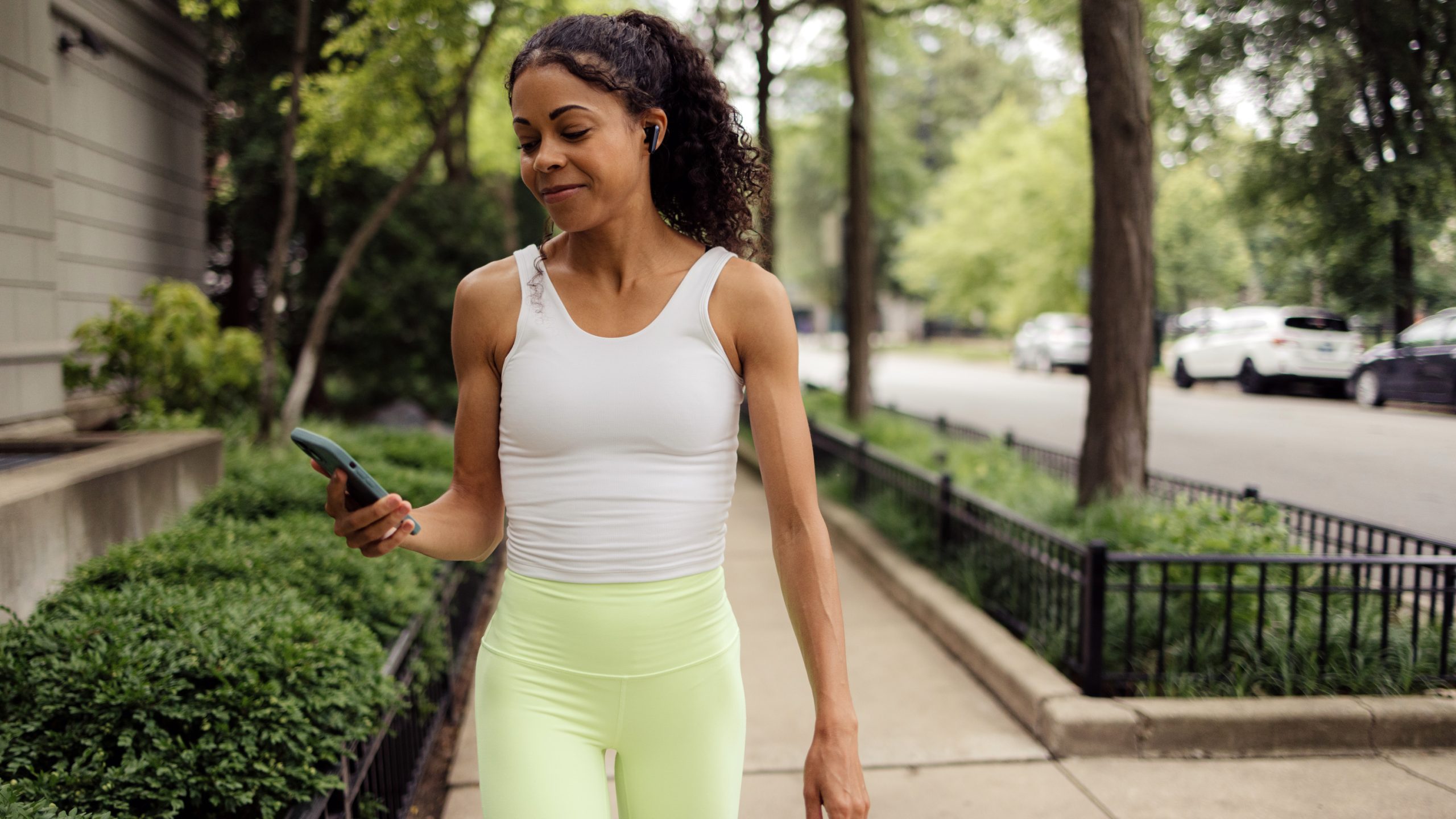 a woman walking and looking at her phone