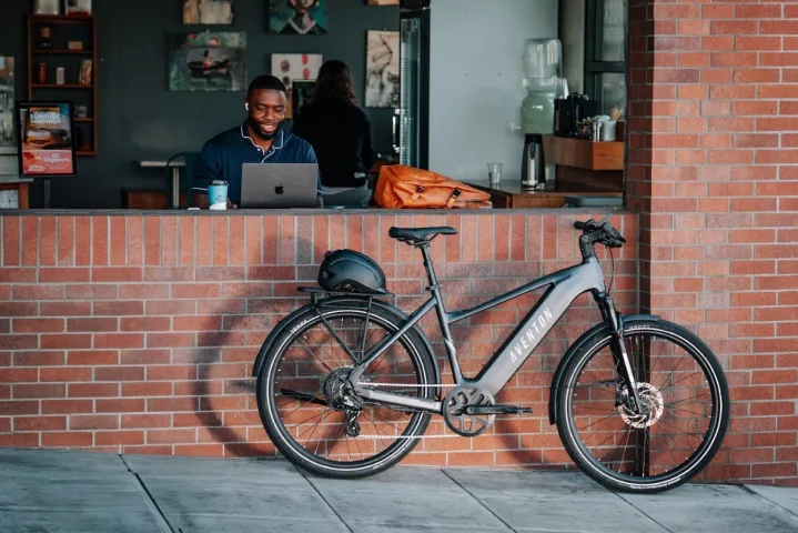An Aventon level 3 securely parked outside a cafe.