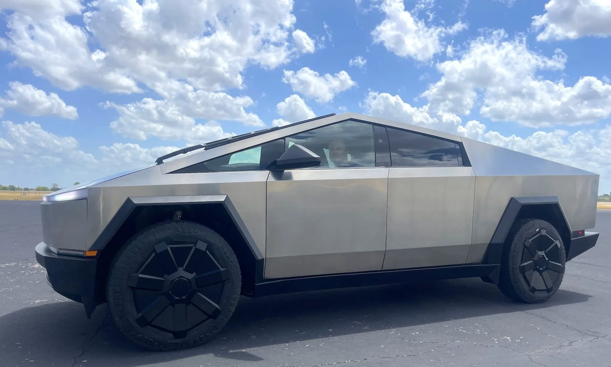 Tesla CEO Elon Musk behind the wheel of a Cybertruck.