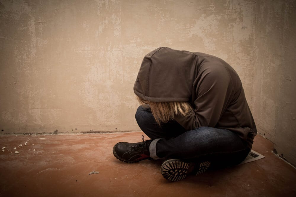 امرأة حزينة جاسة على سطح المبني