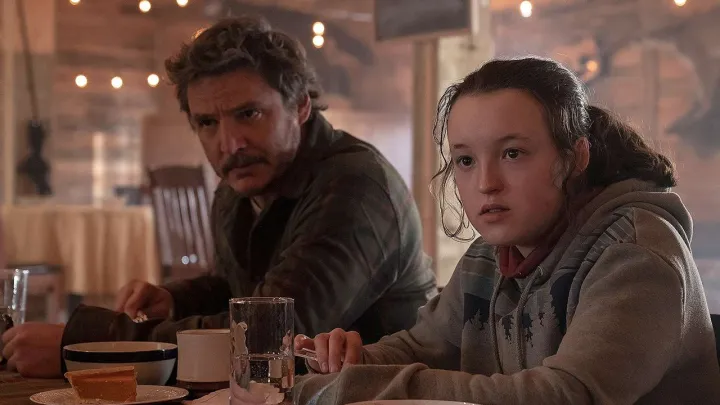 Joel and Ellie sitting together at a bar in The Last of Us season 2.