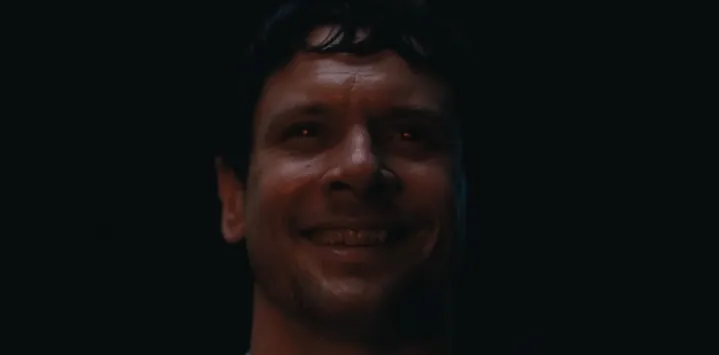 Remmick with glowing red eyes in "Sinners."