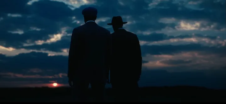 Smoke and Stack looking out at the sunset in "Sinners."