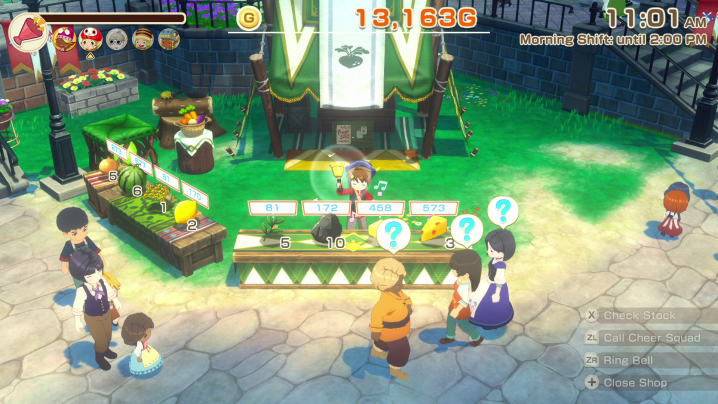 A crowd huddles around a stall selling goods.