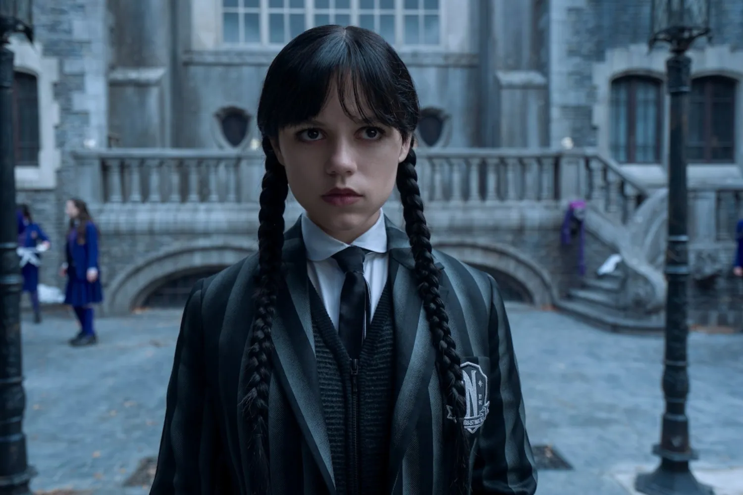 Wednesday Adams stands and looks confused.