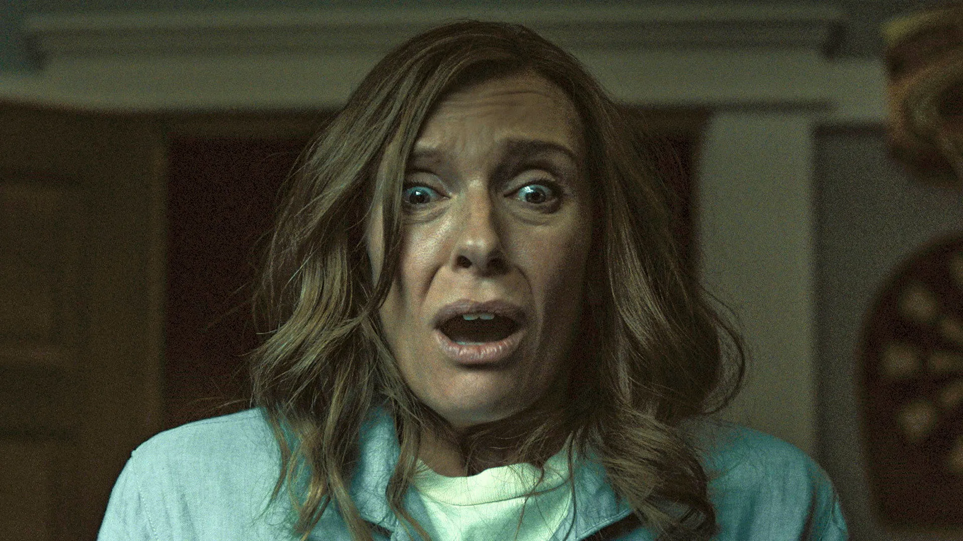 Toni Collette with a shocked and fearful expression in Hereditary from A24.