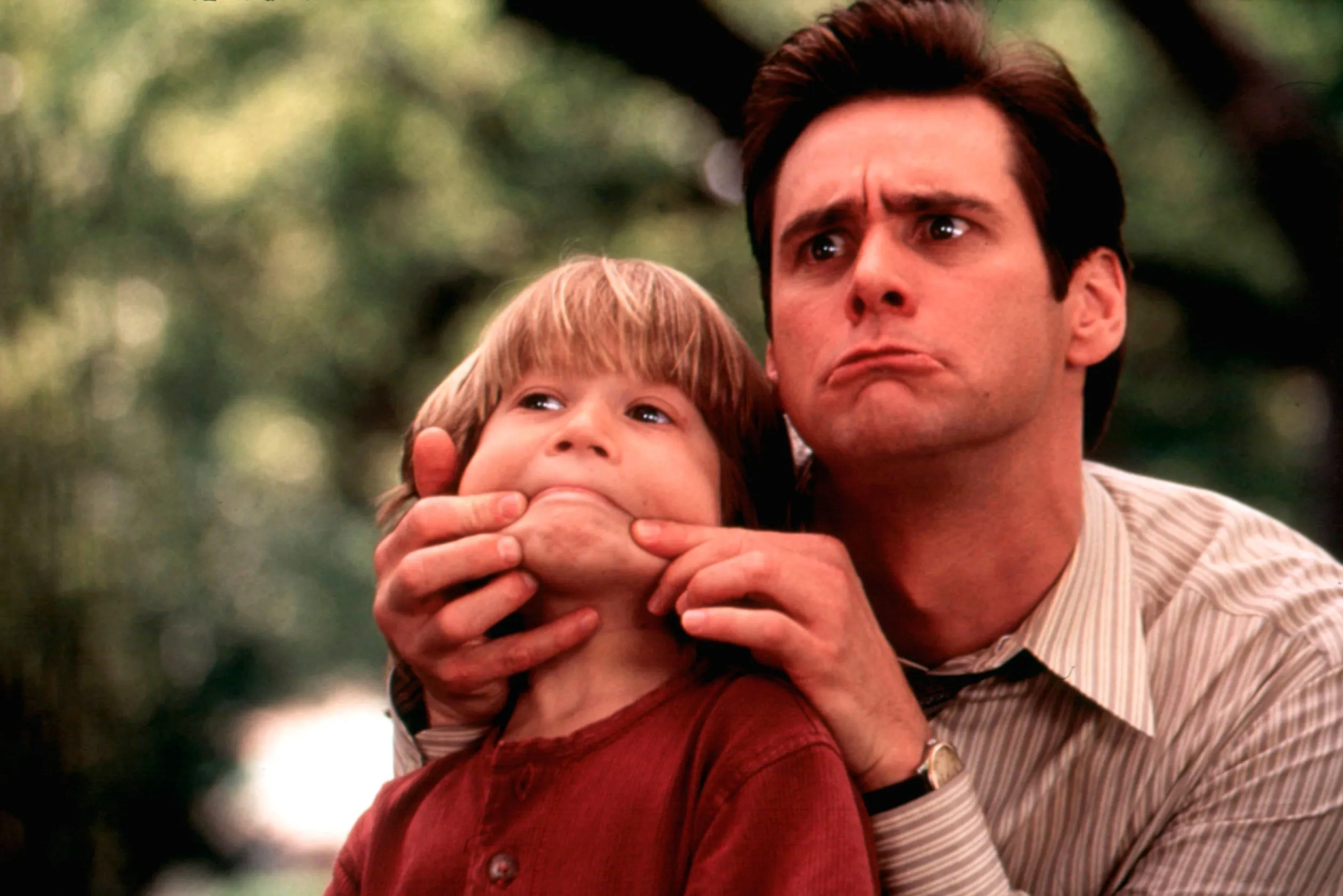 Jim Carrey pulls back on a boys face in Liar Liar.