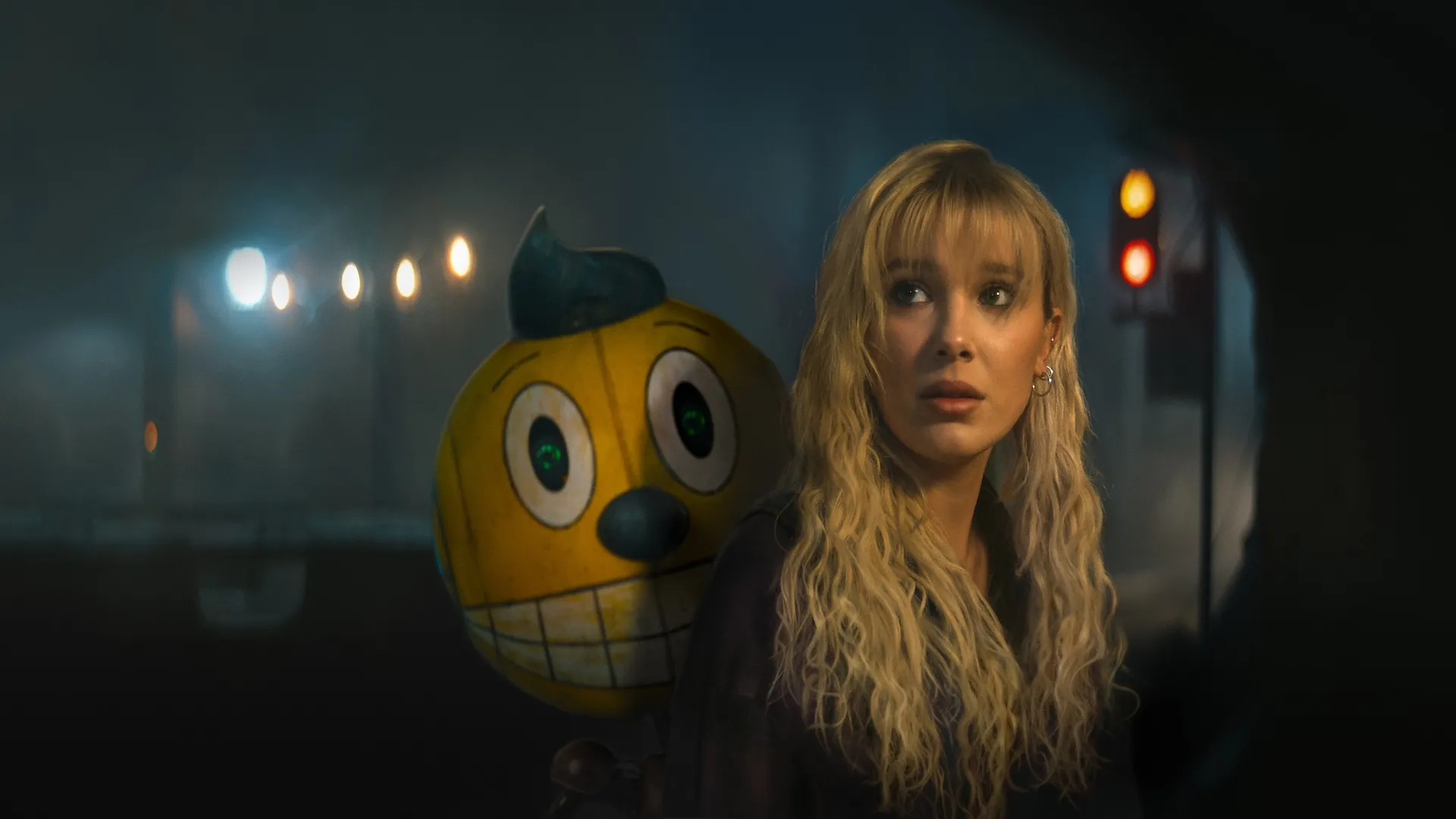 Millie Bobby Brown looks back with a robot behind her in "The Electric State."