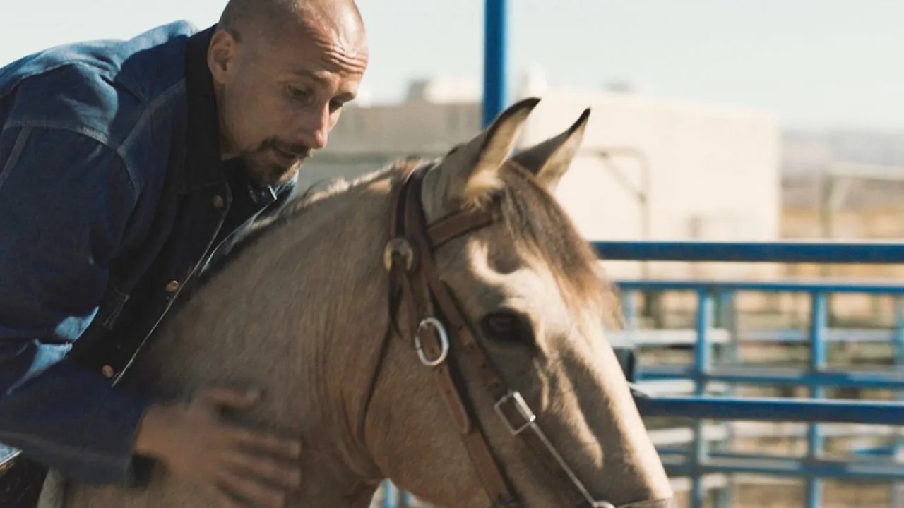 A man rides a horse in The Mustang.