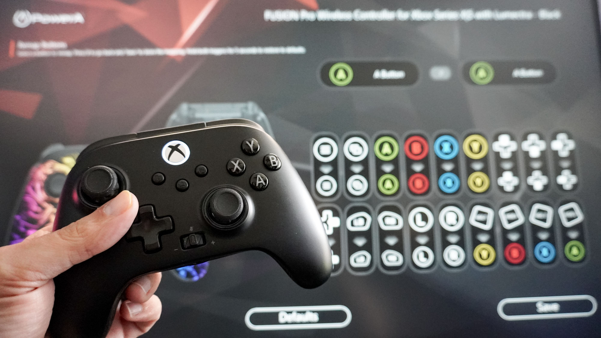 A person holding the PowerA Fusion Pro Wireless Controller up in front of the PowerA Gamer HQ app running on an Xbox