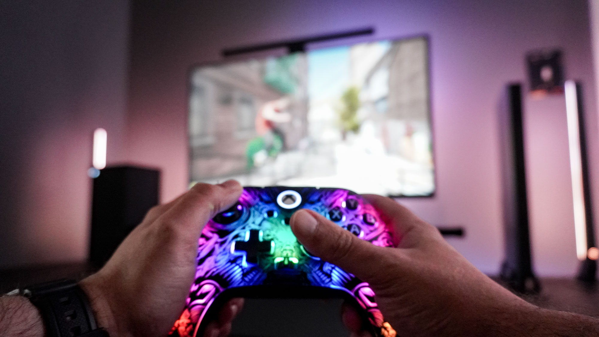 Playing games with the PowerA Fusion Pro Wireless Controller with a monitor and Xbox Series X in the background