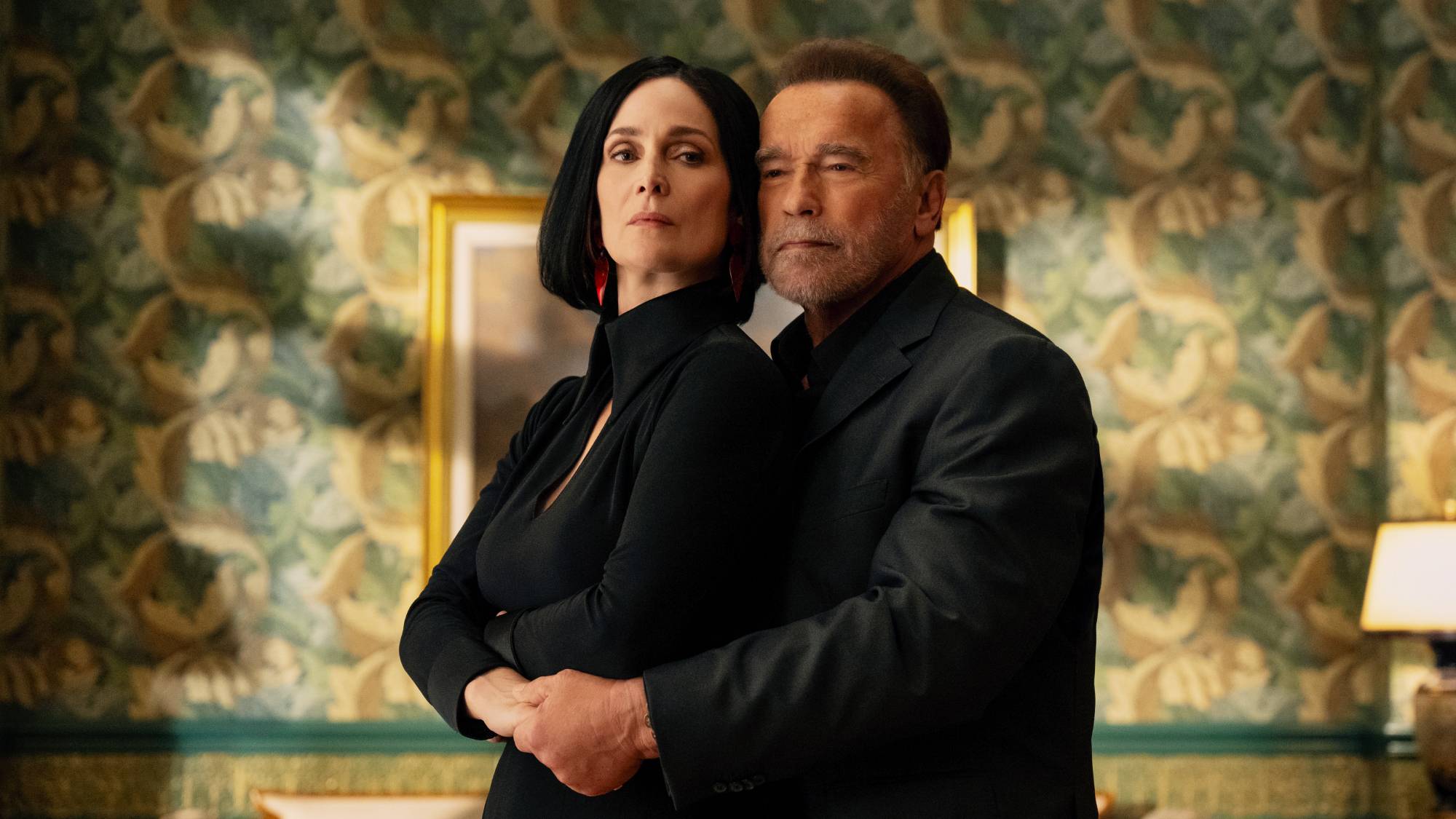 Carrie-Anne Moss as Greta Nelso and Arnold Schwarzenegger as Luke Brunner in &quot;Fubar season 2&quot;