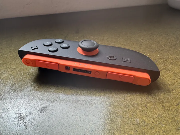 A Nintendo Switch 2 Joy-con sits on a table.
