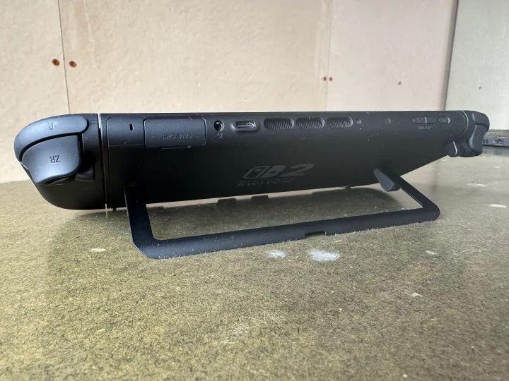 A Nintendo Switch 2 sits on a table using its kickstand.