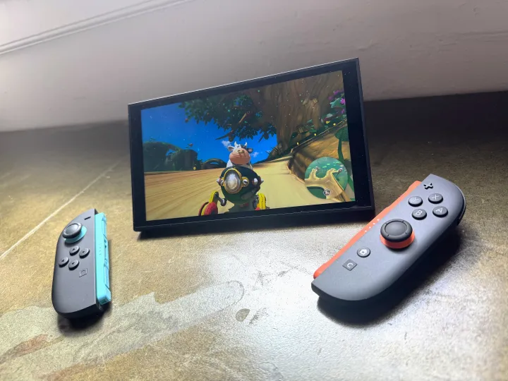 A Nintendo Switch 2 playing Mario Kart World appears on a table.
