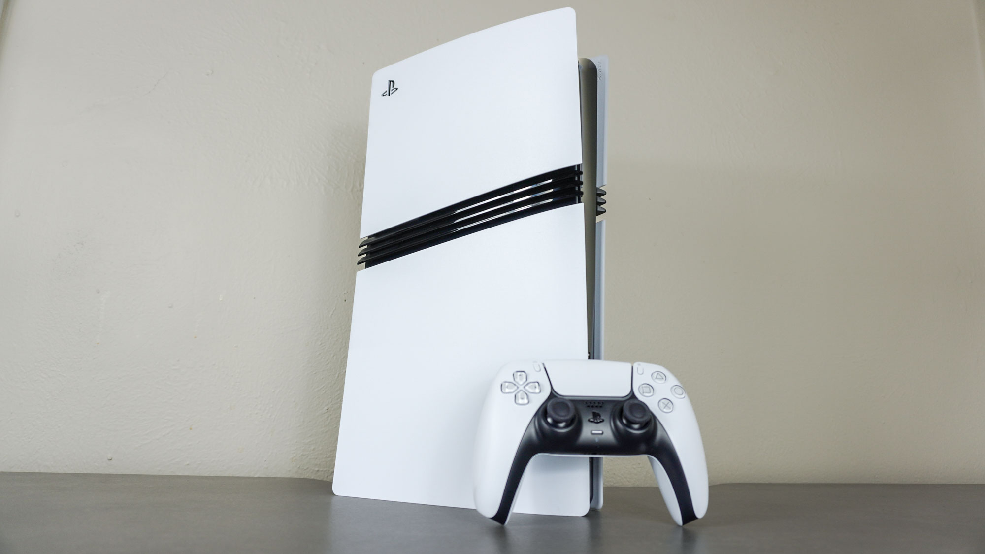 The PS5 Pro with a DualSense controller on a desk