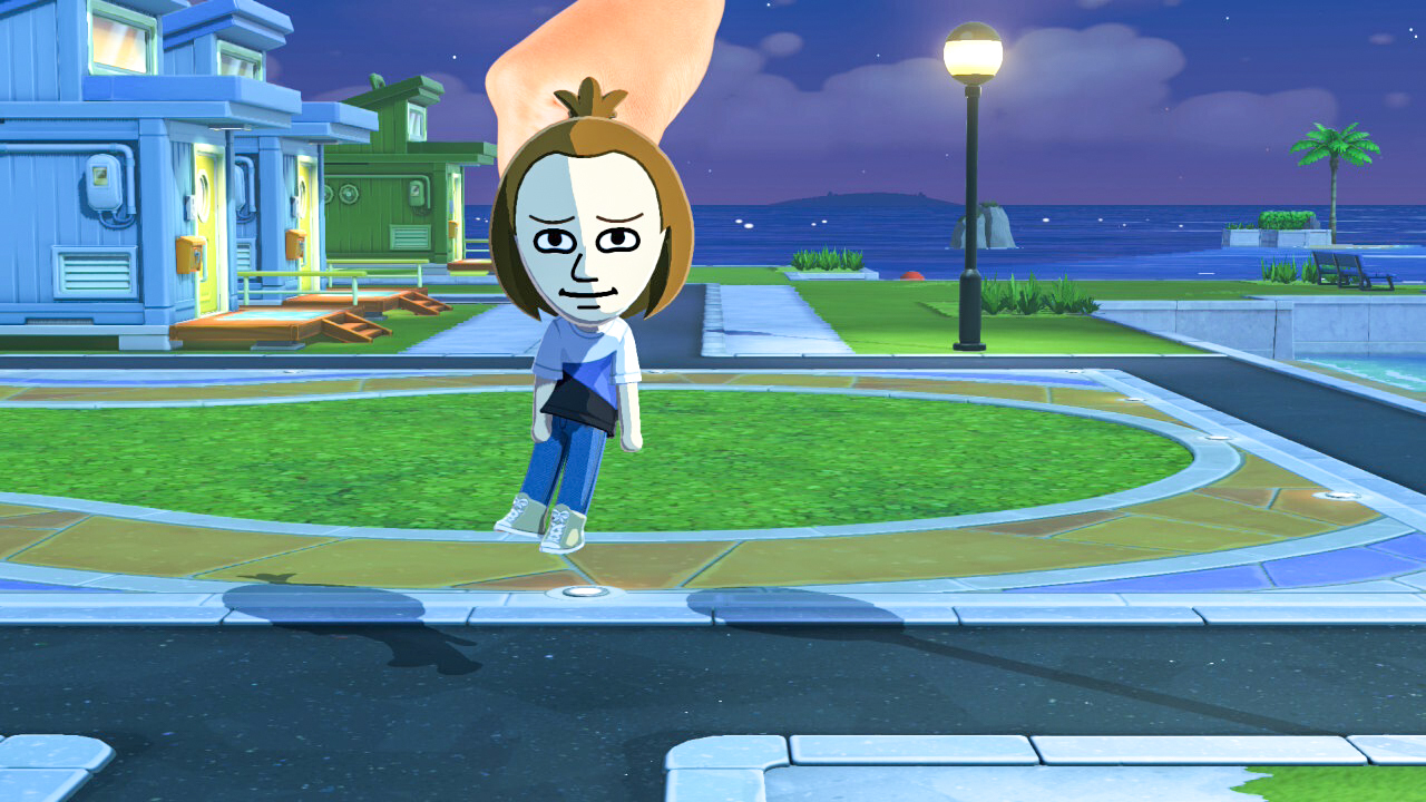 لقطة شاشة من Tomodachi Life: Living the Dream تظهر يدًا تلتقط شخصية Mii وتحركها إلى مكان آخر
