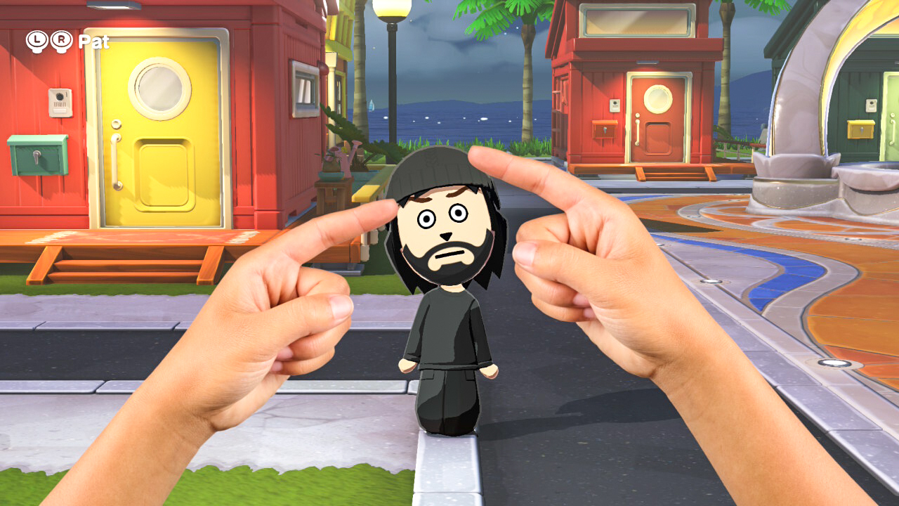 لقطة شاشة تظهر يدين تضغطان على شخصية Mii في Tomodachi Life: Living the Dream