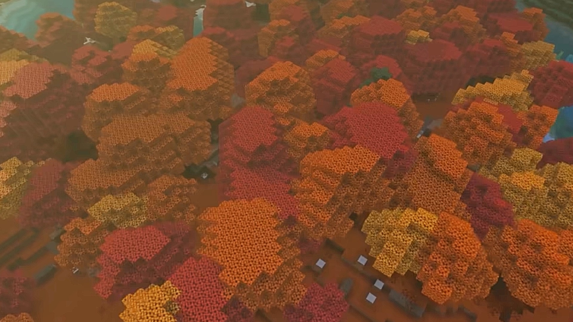 منظر علوي لغابة الظلال المتراقصة من تحديث Minecraft القادم، يظهر بحرًا من قمم الأشجار ذات اللون البرتقالي.