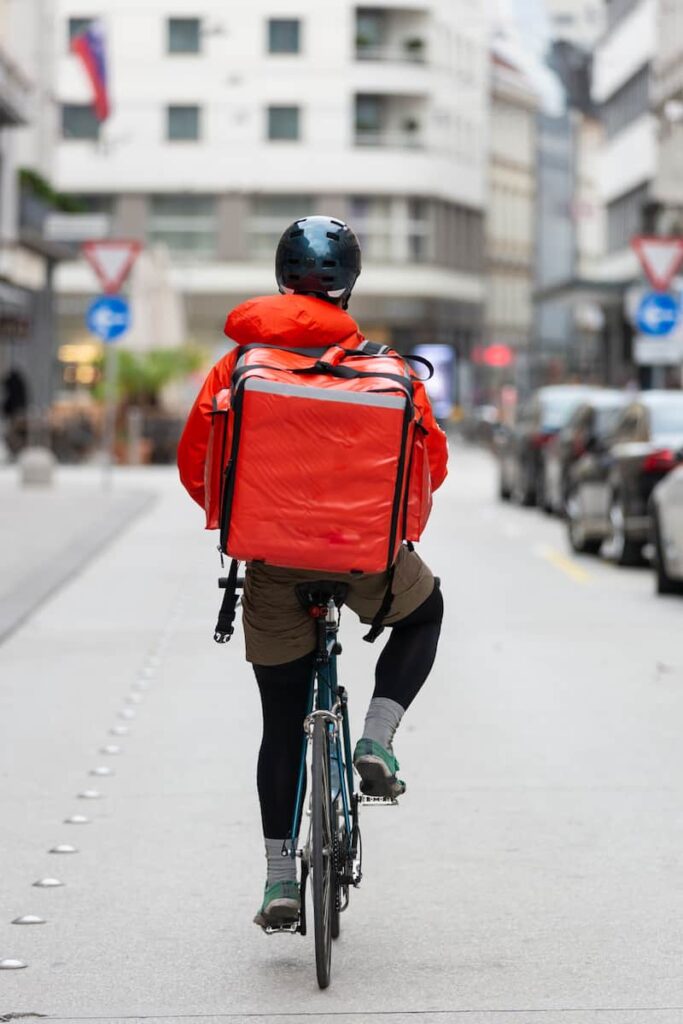 a delivery man riding a bicycle