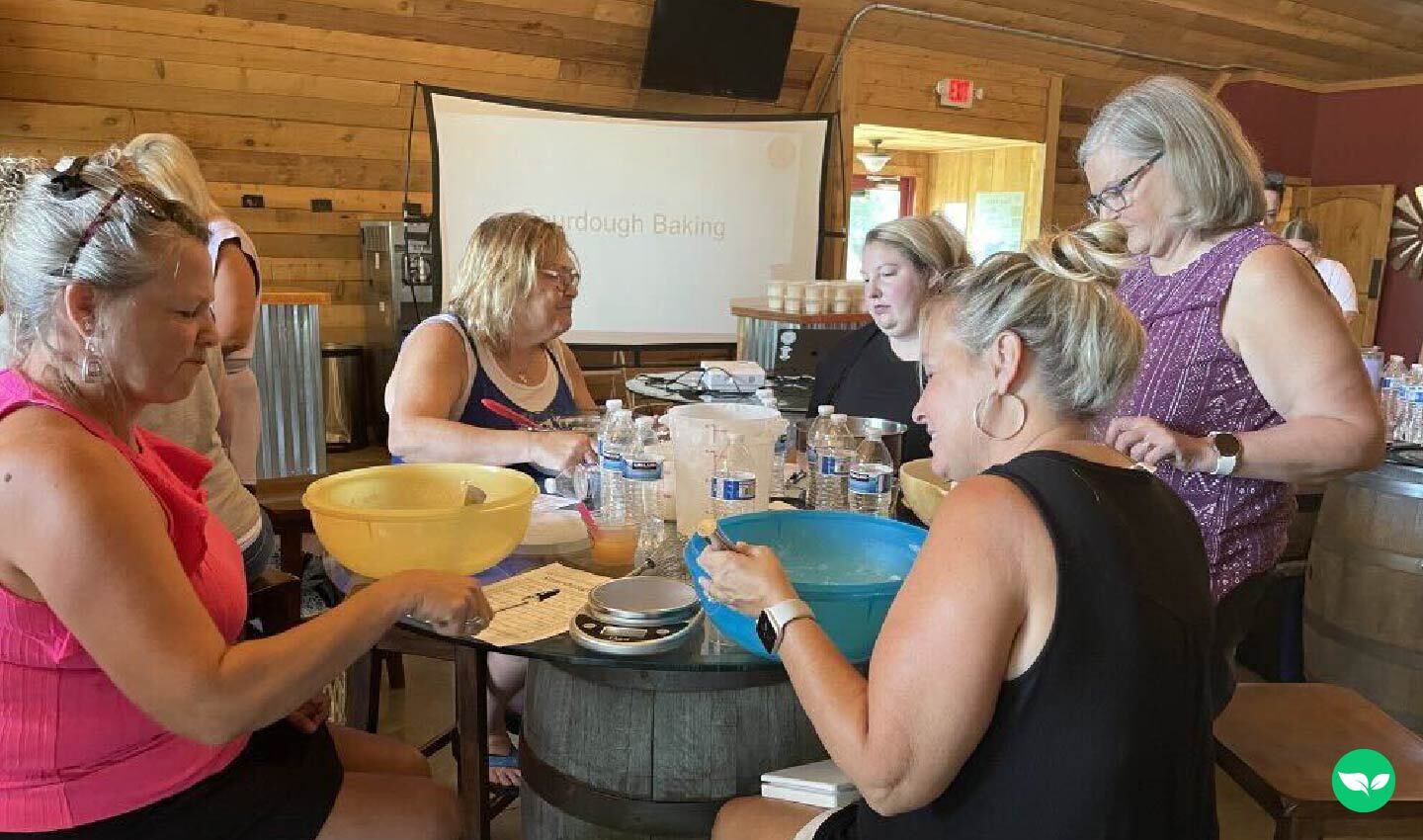Presso la KC Wine Co. di Kansas City, i partecipanti misurano gli ingredienti e impastano durante un corso di panificazione con lievito madre.