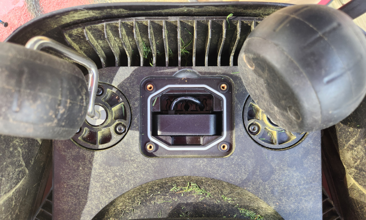 Underside of a Segway Navimow i110 robot lawn mower with the compartment cover removed and Access+ 4G module installed and plugged in.