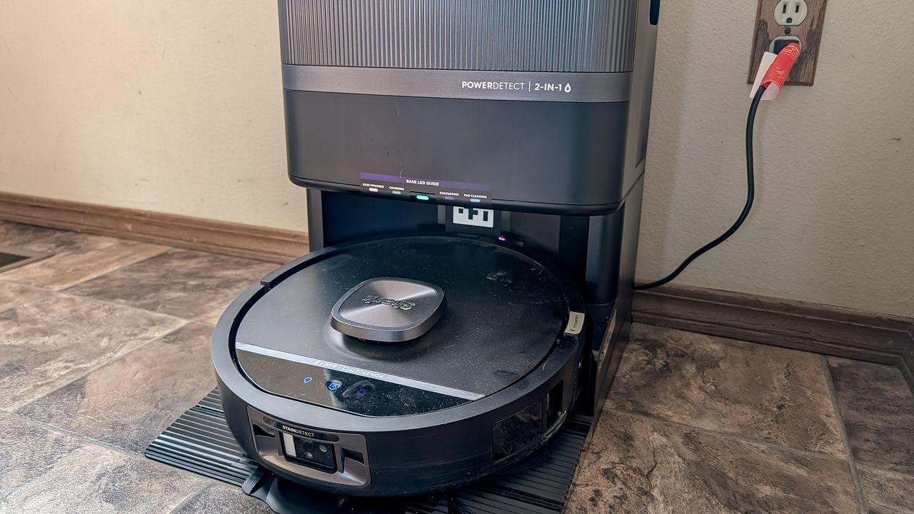 مكنسة Shark UV Reveal PowerDetect Robot Vacuum وقاعدة الشحن الخاصة بها على أرضية المطبخ