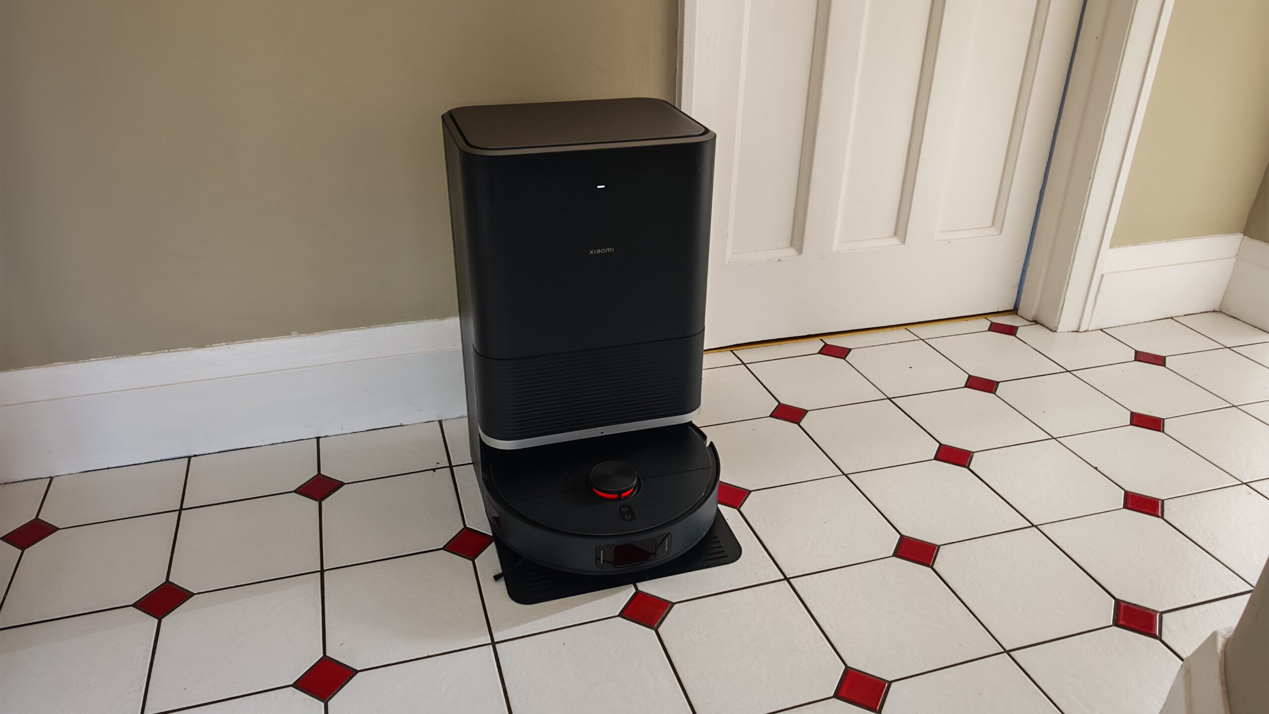 مكنسة Robot Vacuum X20 Max من Xiaomi في ممر بأرضية مبلطة.