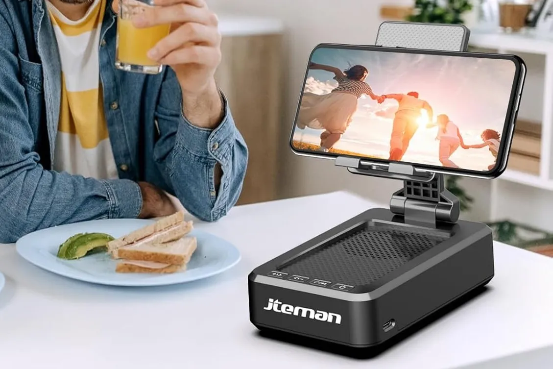 iPhone on a speaker doc on white table