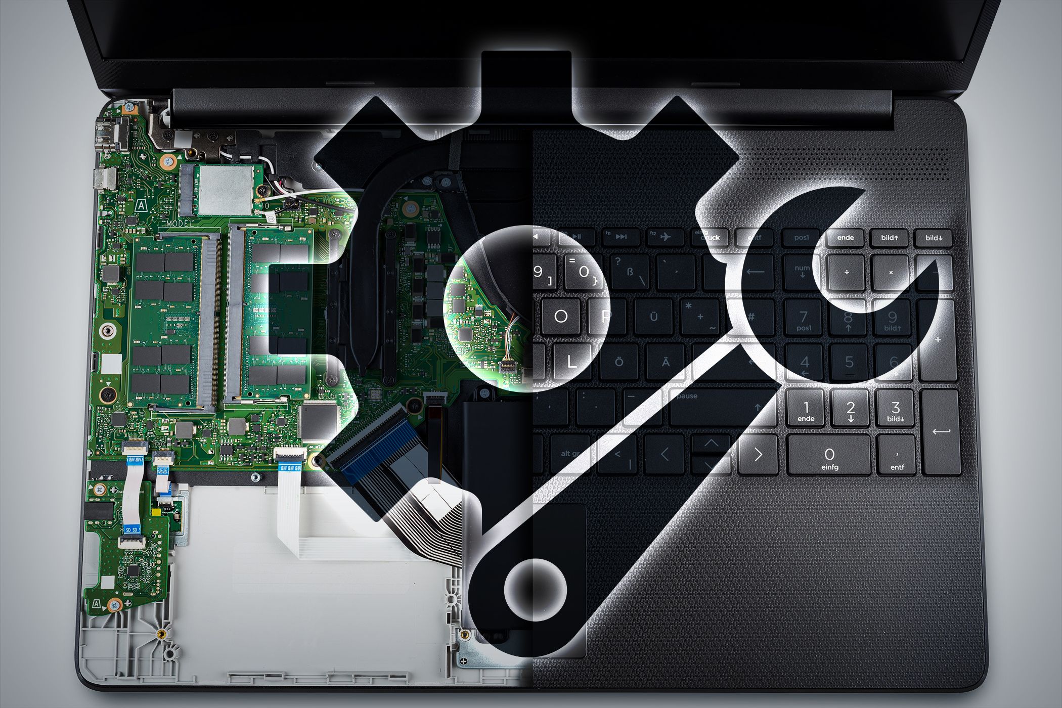 Laptop with a half-exposed circuit board, overlaid with a gear and wrench icon, symbolizing hardware repair or customization.