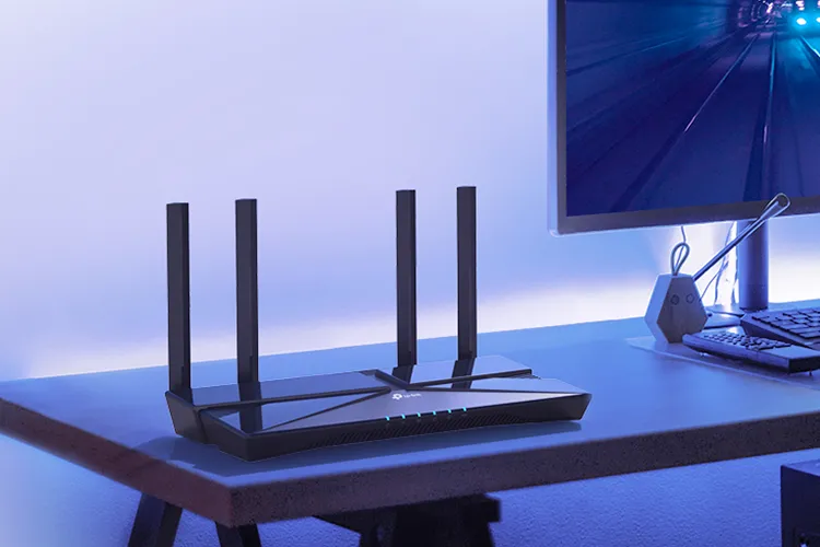 A TP Link Archer AX3000 Wi-Fi 6 router on a desk