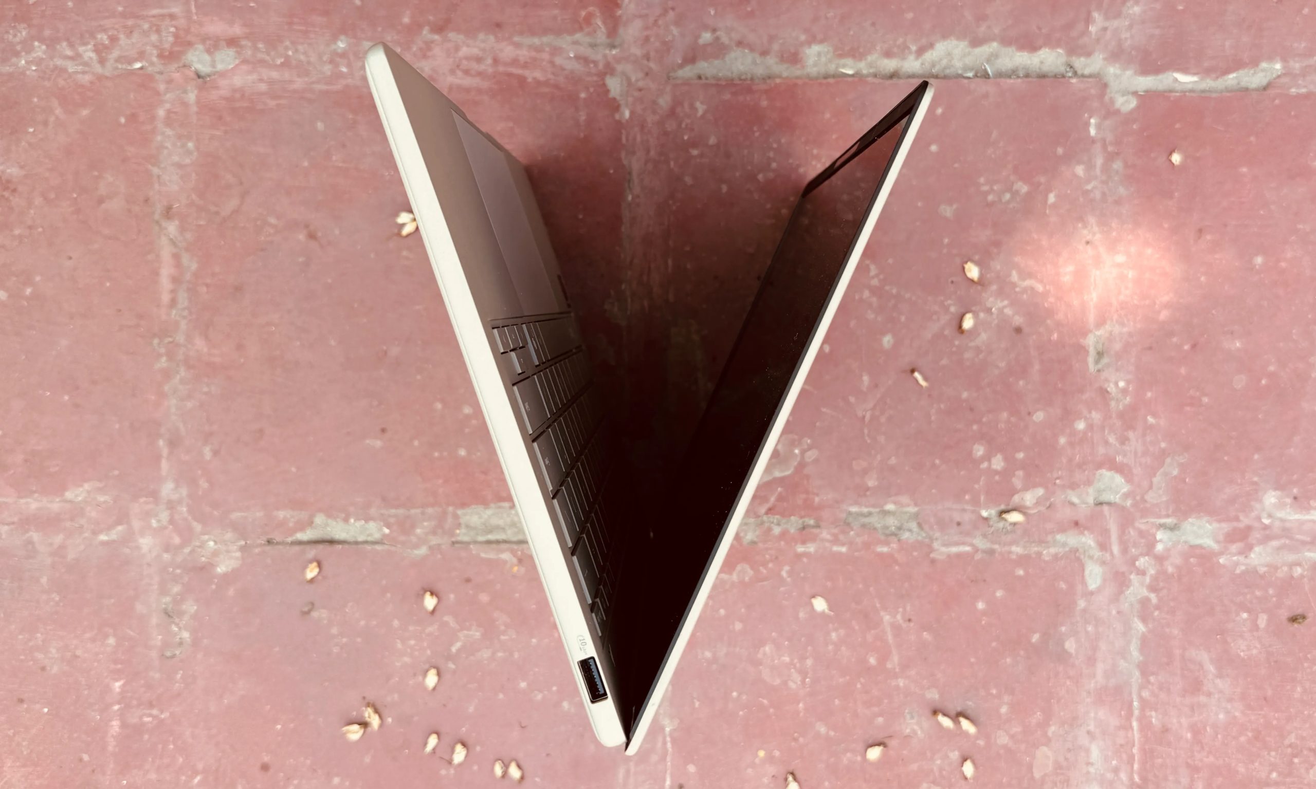 Side top view of the Asus ZenBook A14 laptop.