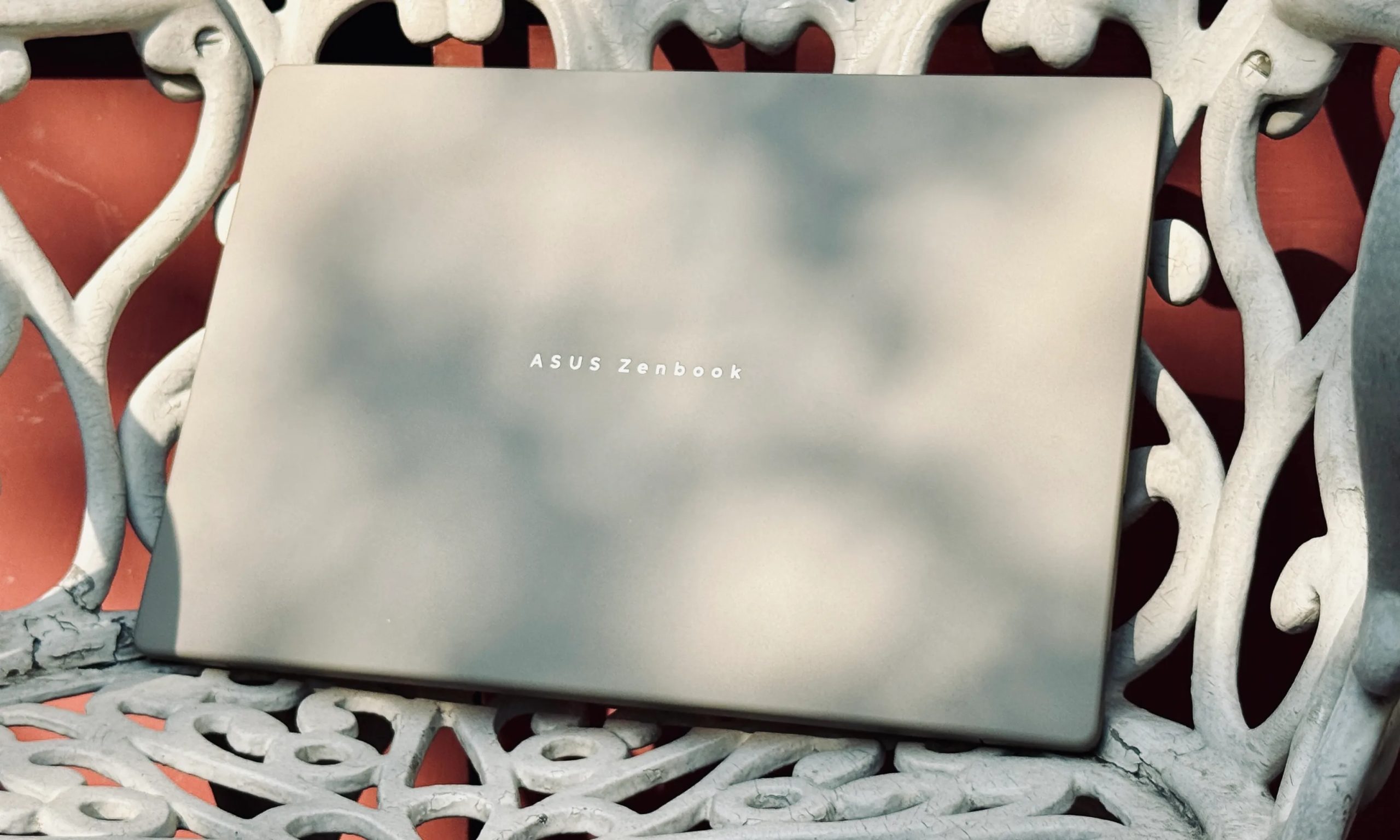 Asus ZenBook A14 laptop on a chair.