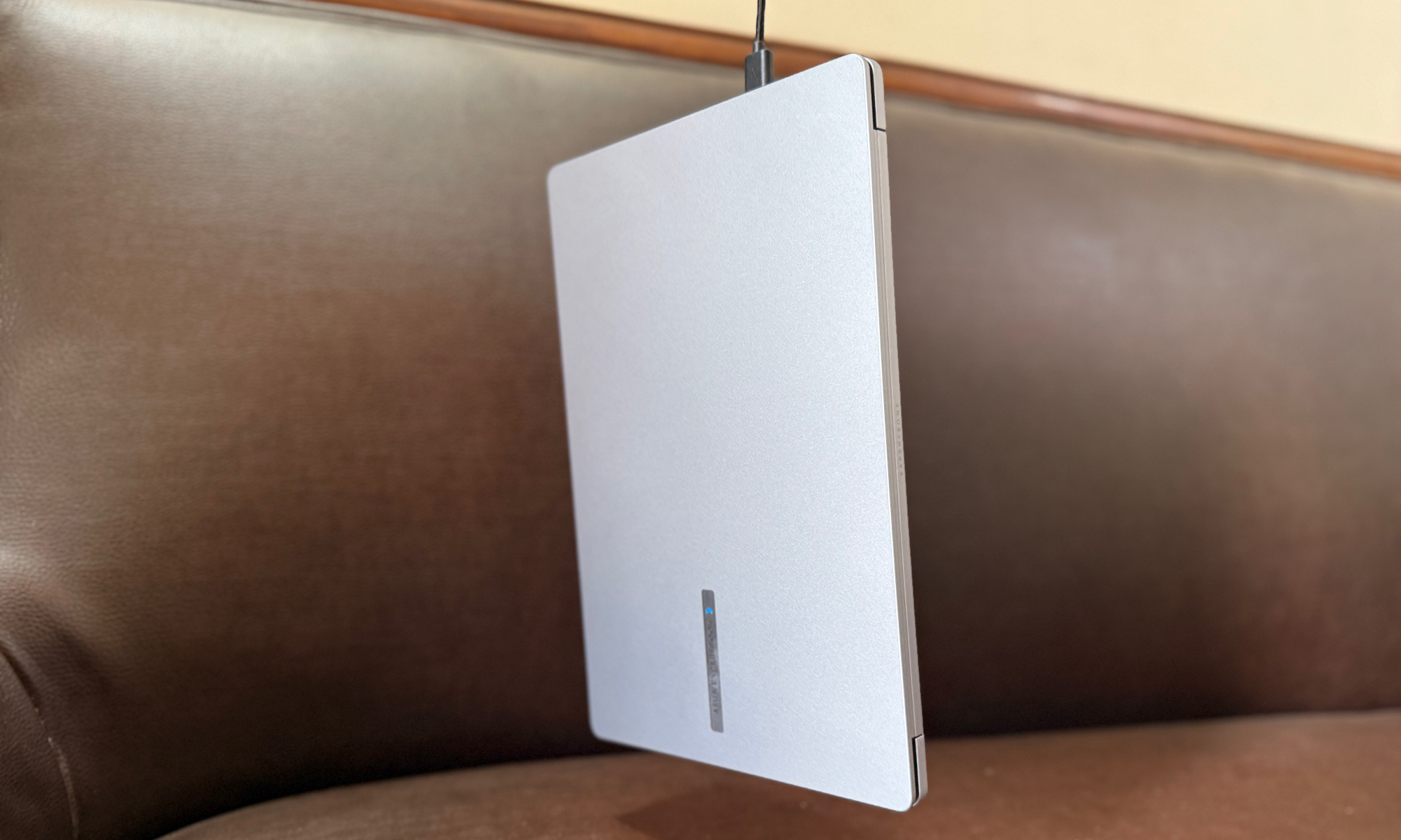 Asus ExpertBook P1 hanging by a USB port.