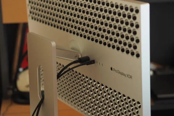 Apple Pro Display XDR rear view showing stand attachment and cheese grater vents.