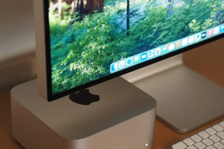 Apple Pro Display XDR lower angle view showing screen and stand next to Mac Studio.