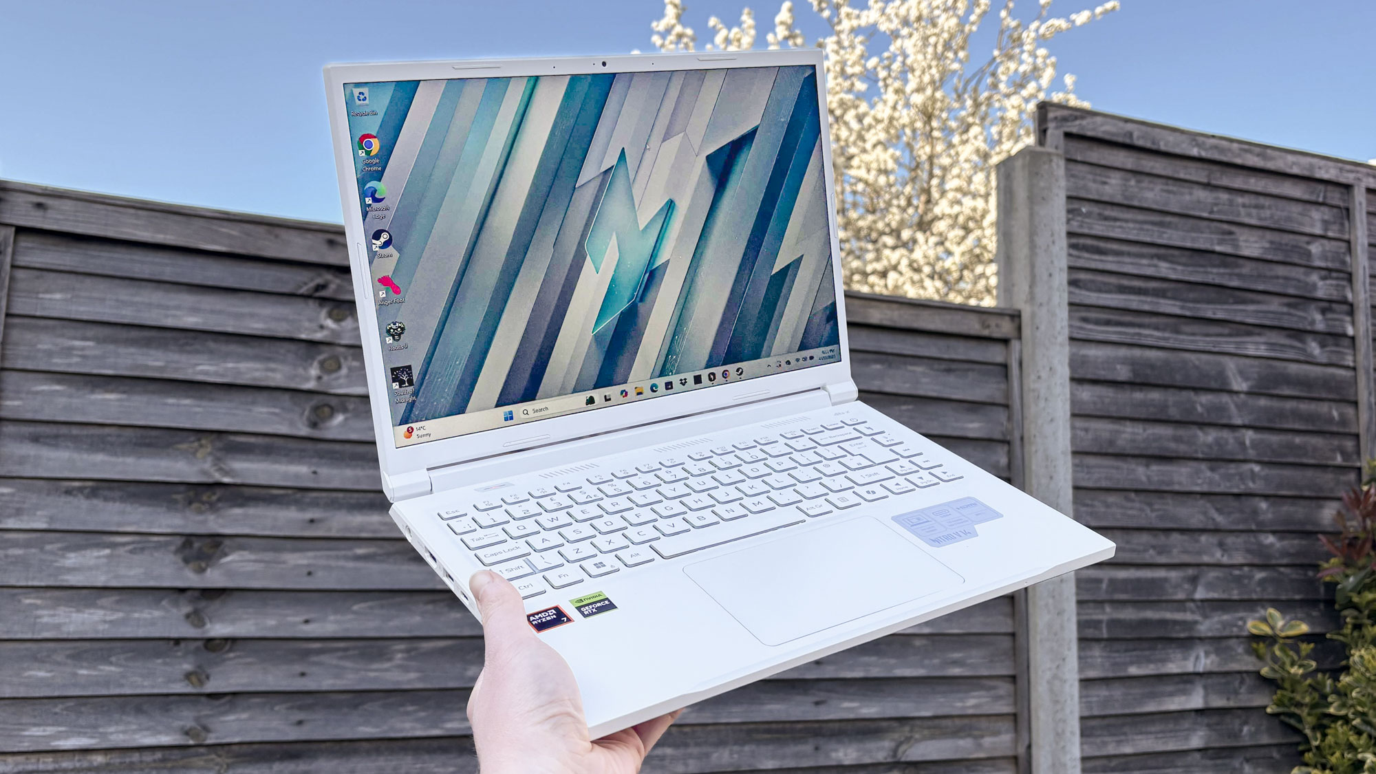 Acer Nitro V 14 Pearl White in hand with outside background