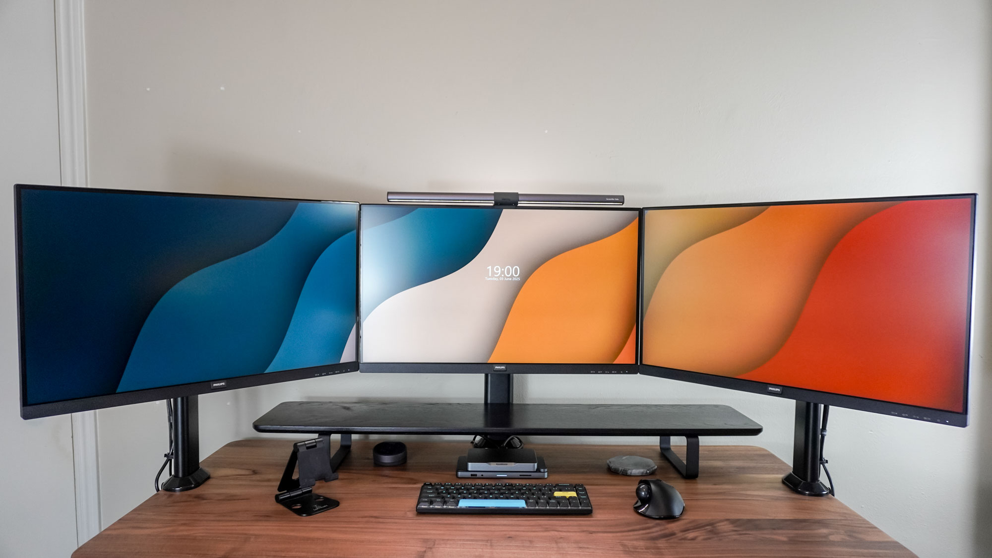 A triple monitor setup on a desk
