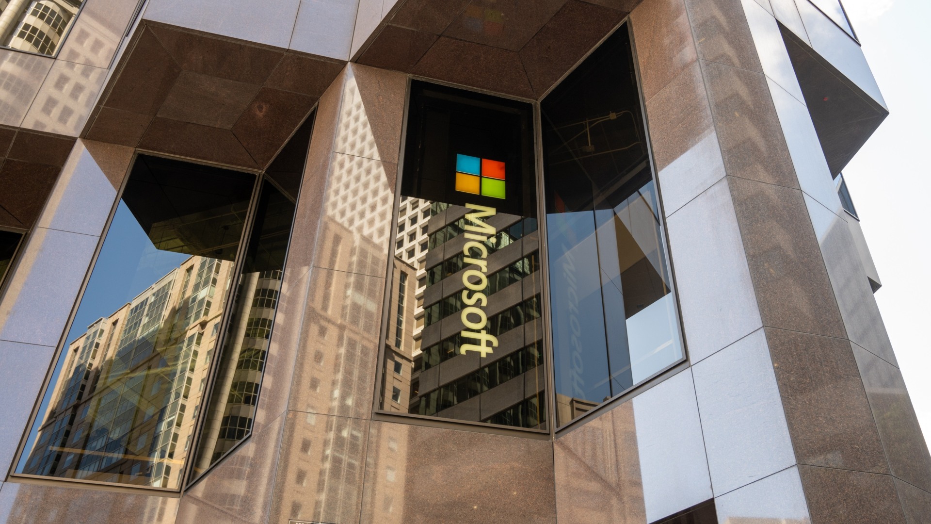 Facade of Microsoft office building with logo and reflective glass windows, San Francisco, California, May 13, 2025.