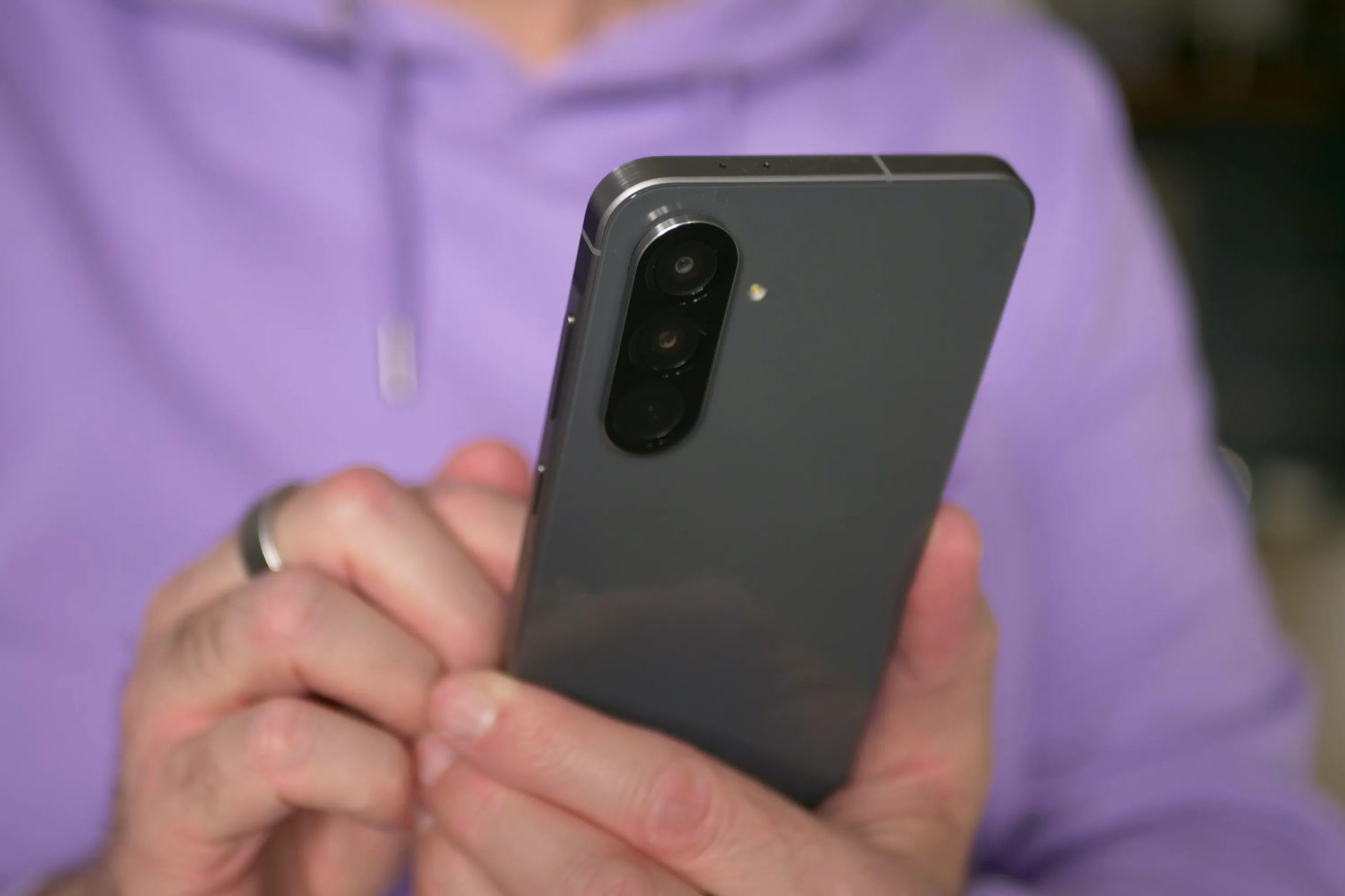 A person holding the Samsung Galaxy A56.