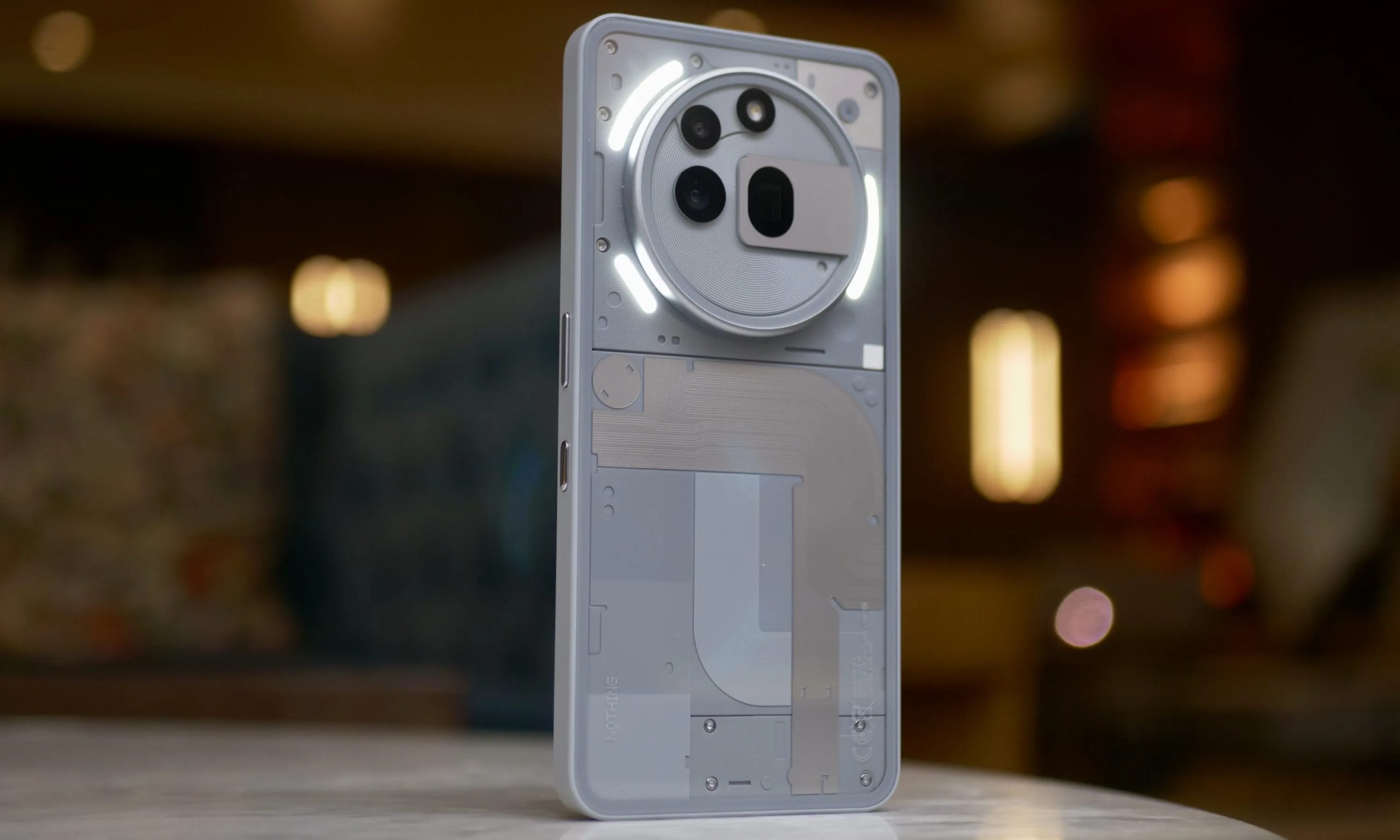 The back of the Nothing Phone 3a Pro, with the Glyph Lights active.