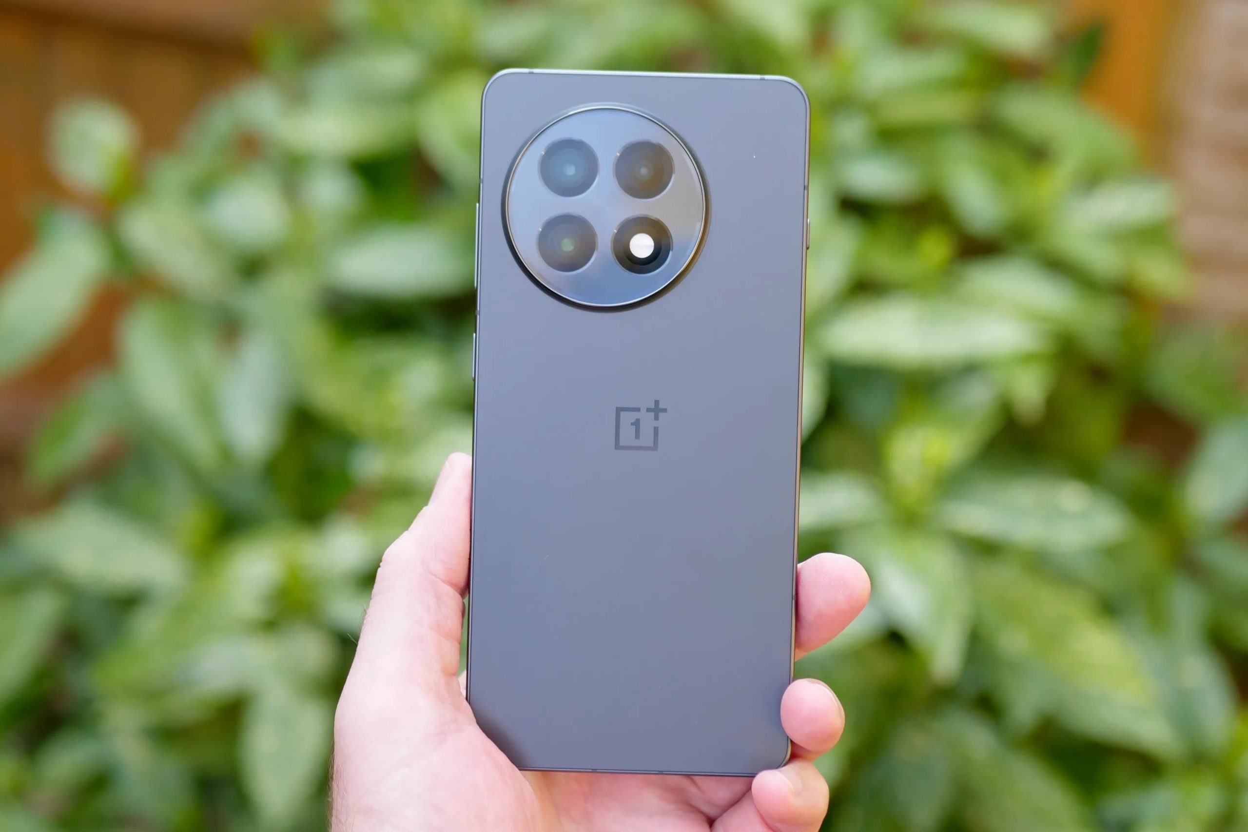 A person holding the OnePlus 13R.
