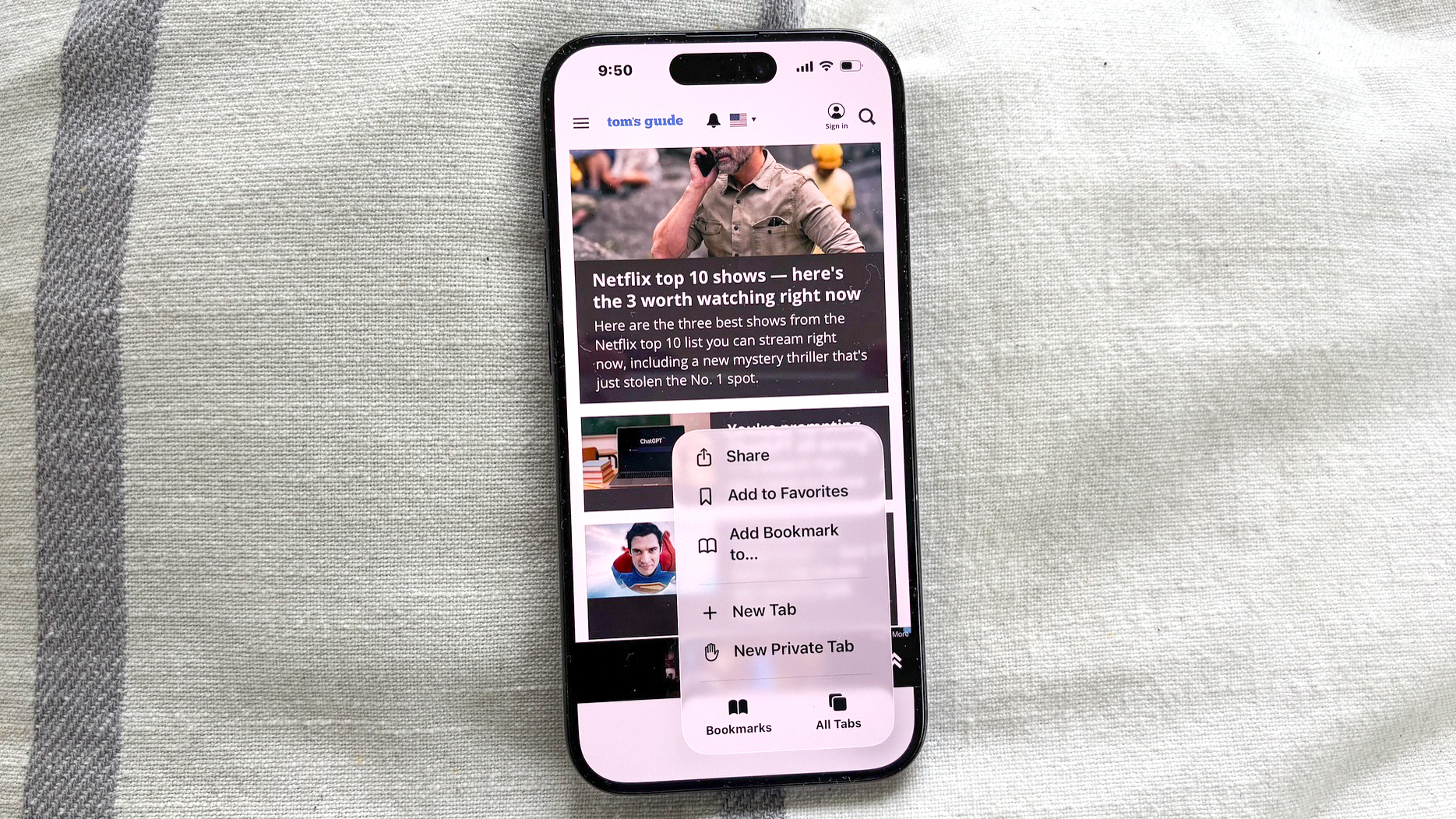 the new tab design in iOS 26 safari with a translucent popup menu showing bookmark and favorite controls