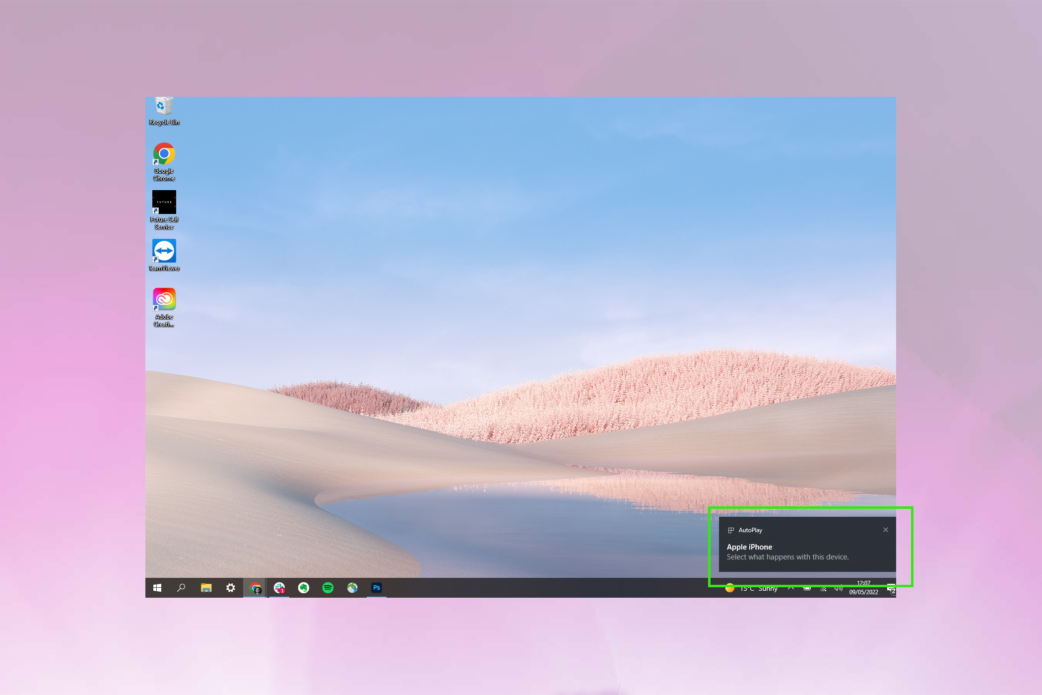 Windows 10 home screen showing an iPhone popup in the bottom right corner.