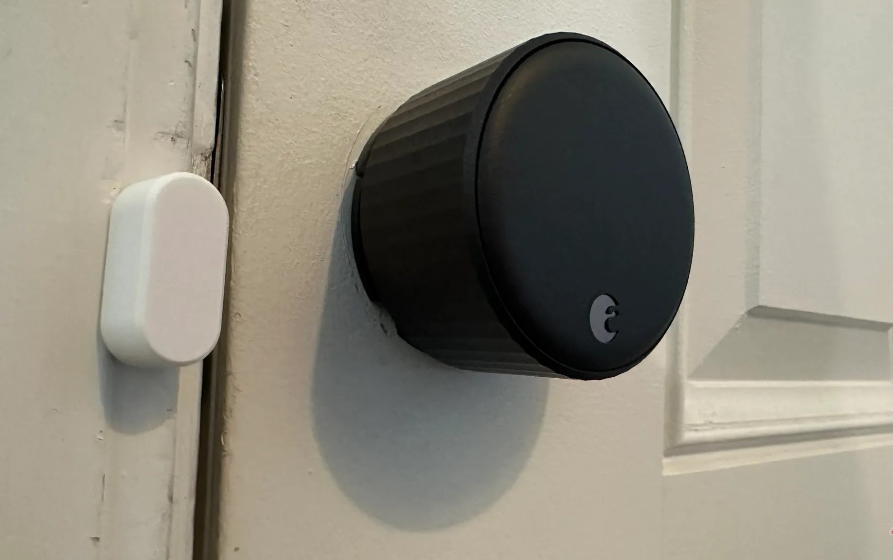 August Wi-Fi Smart Lock with its sensor